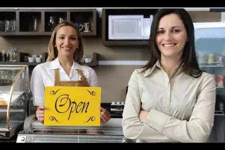 Women with shop open sign