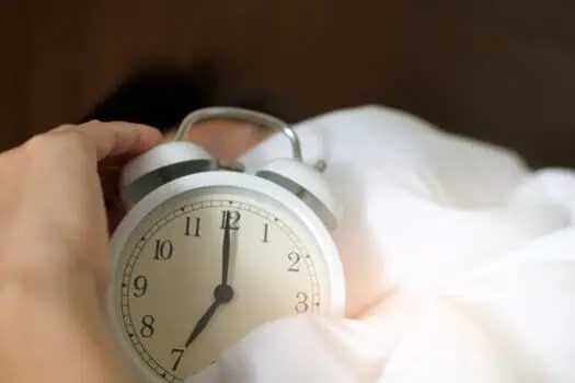 Midnight alarm clock in bedroom, sleep disorder awareness, morning wake-up routine, time management, health and wellness concept.