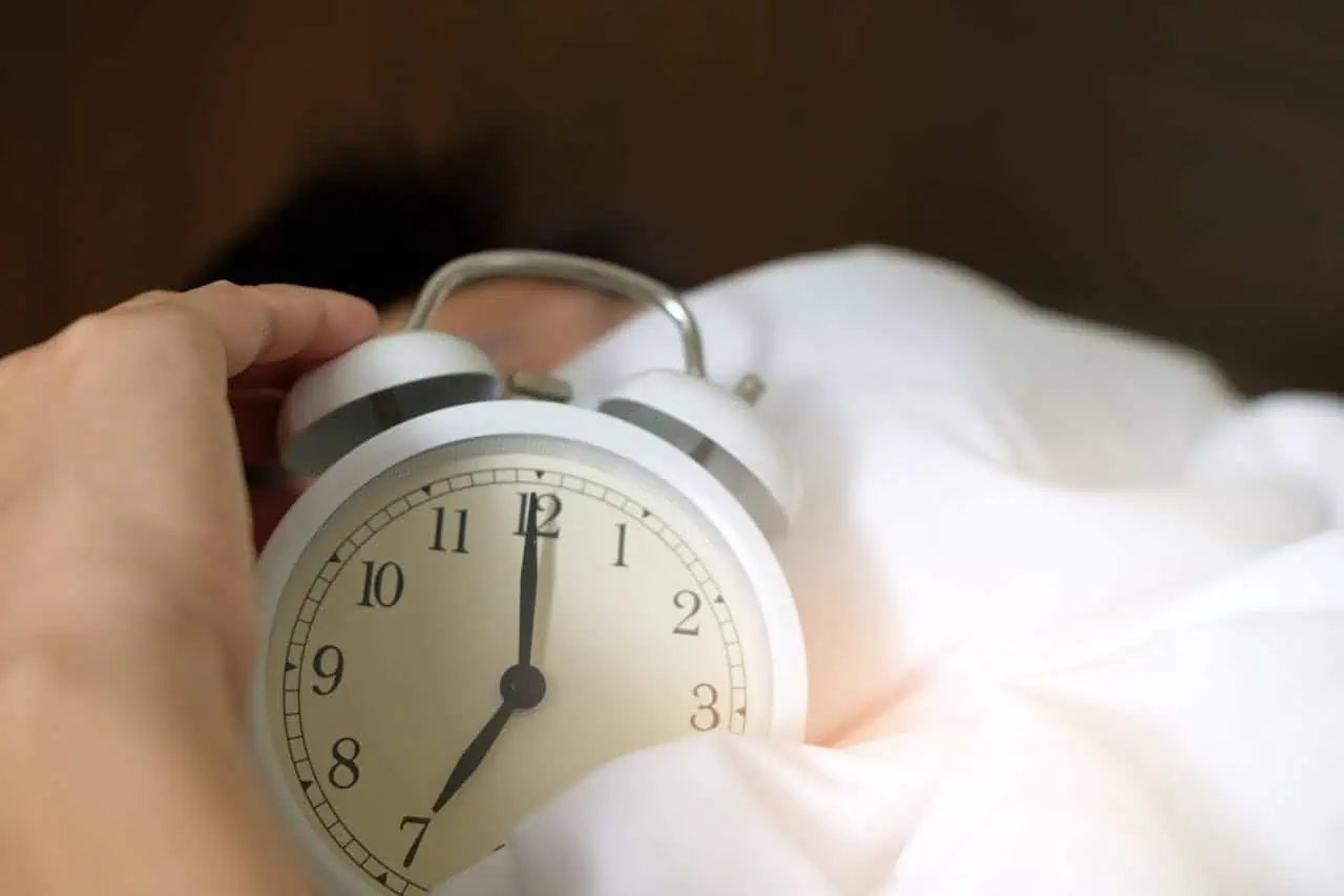 Midnight alarm clock in bedroom, sleep disorder awareness, morning wake-up routine, time management, health and wellness concept.