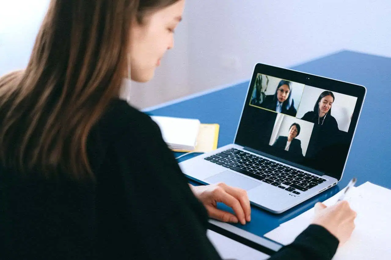 Virtual team meeting or online conference call with diverse professionals on a laptop screen, demonstrating remote working or virtual teamwork.