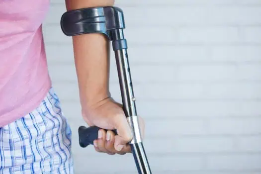 Comfortable prosthetic arm with metal rod and black handle, demonstrating assistive technology for limb difference support and rehabilitation.