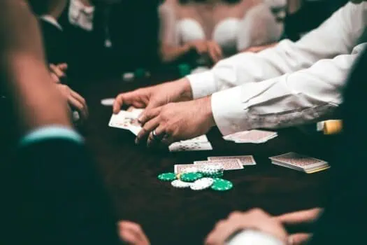 Playing cards and poker chips on a casino table during a poker game or gambling session.