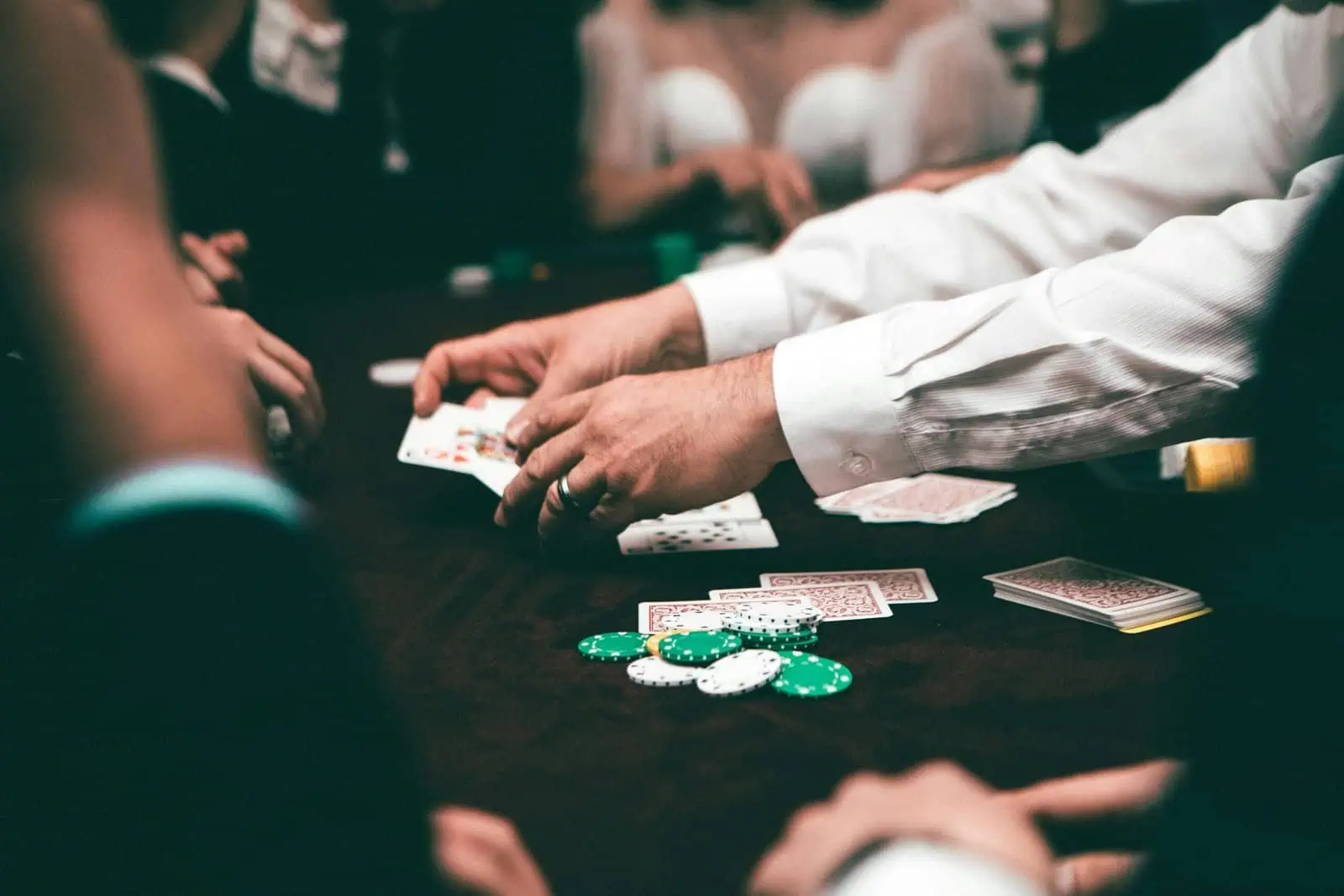 Playing cards and poker chips on a casino table during a poker game or gambling session.