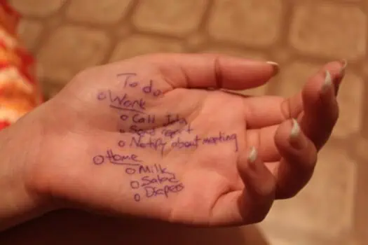 To do list written on a hand with tasks like call John, send report, and notify about meeting. The image highlights organisation, task management, and personal productivity.