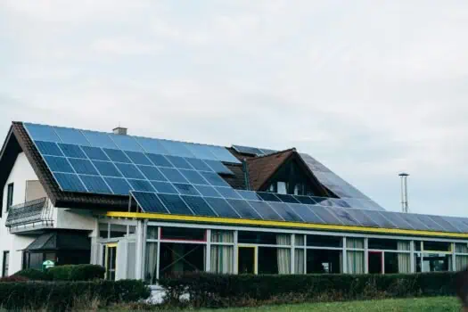 Solar panels installed on the roof of a residential building, promoting renewable energy and eco-friendly living. The image showcases sustainable energy solutions for modern homes.