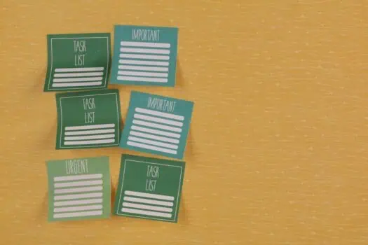 Task management task list notes on colourful sticky notes on wooden surface, organisation and prioritisation of important and urgent responsibilities, focus on productivity, planning, work organisation.
