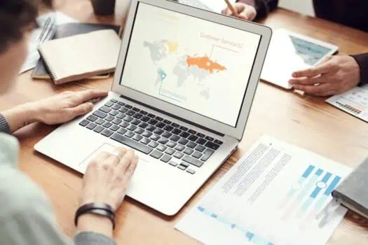 Global business analysis on laptop screen for market research and strategy development.