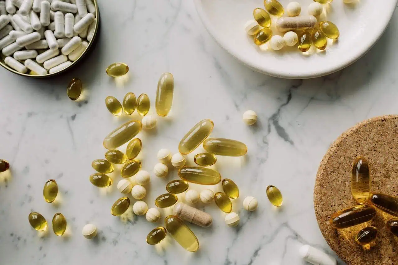 Dietary supplements and vitamins in capsules and tablets on marble surface - health, wellness, nutrition, pharmacy, Prowess.