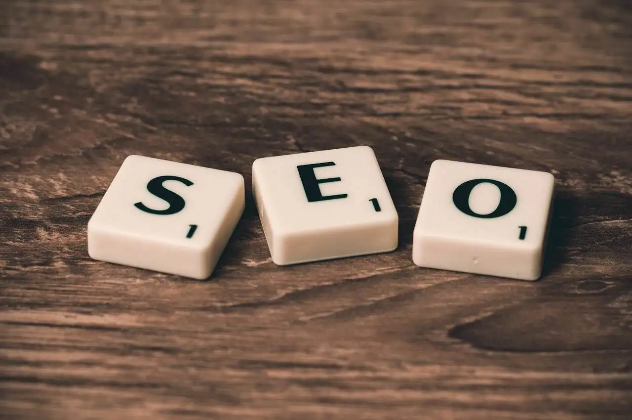 Seo tiles on wooden surface, representing search engine optimisation for website ranking and digital marketing.