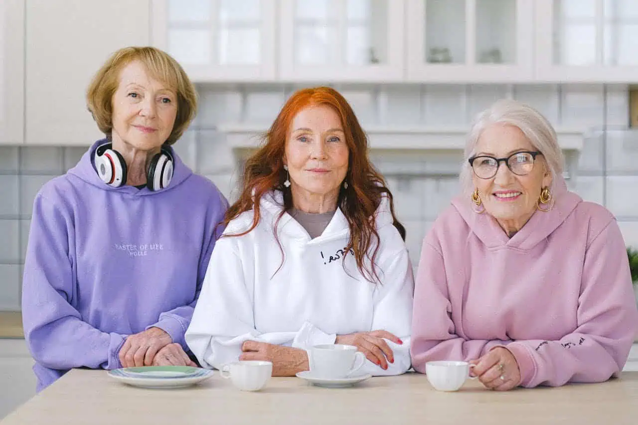 Empowered senior women enjoying coffee together, representing community, friendship, and active ageing with emphasis on support networks for older adults.