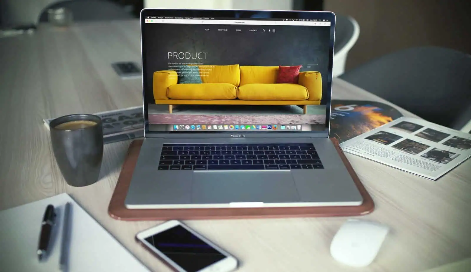 Bright yellow sofa displayed on a website homepage open on a MacBook Pro screen.