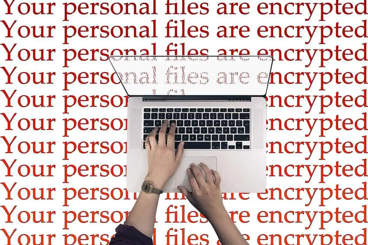 Encrypted personal files on a laptop with a warning message background; cybersecurity, data protection, digital security, data encryption, privacy protection.
