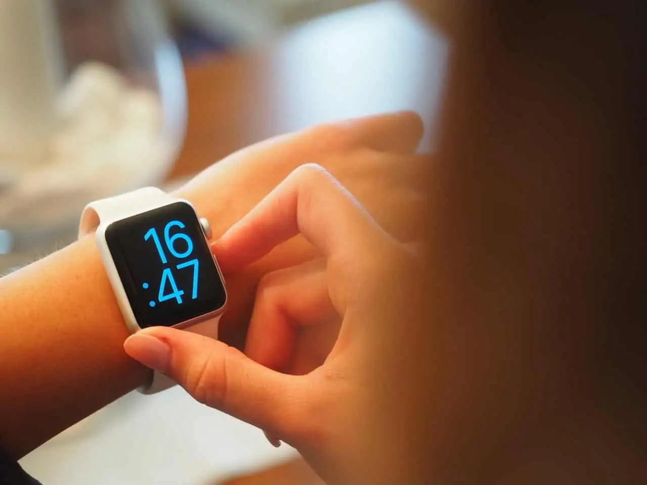 Smartwatch with digital time display on a person's wrist, illustrating modern technology and digital health tools.