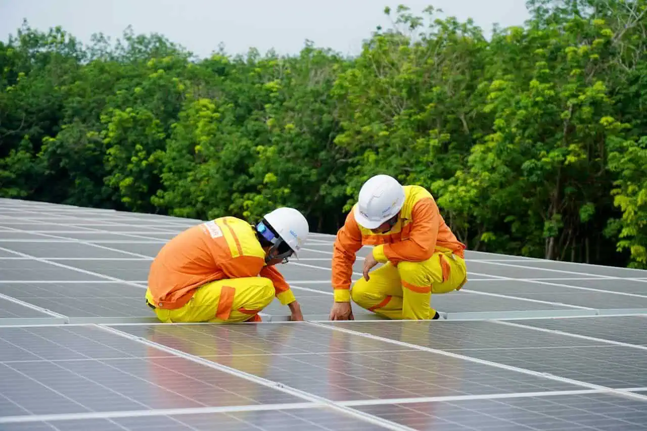 Solar panel installation, solar energy workers, renewable energy, sustainable power, green technology, eco-friendly energy solutions, outdoor solar panel maintenance, environmentally conscious professionals, solar power system setup, solar energy project.