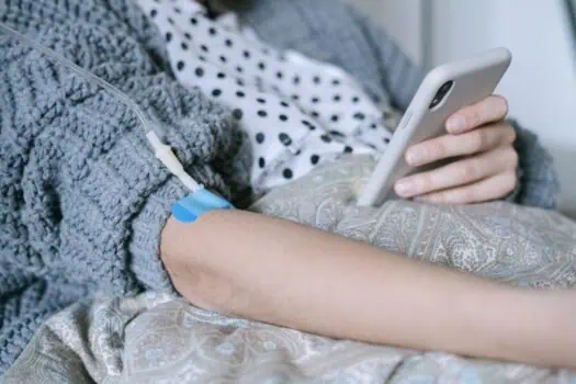 IV therapy patient receiving medication through IV line in hospital bed.
