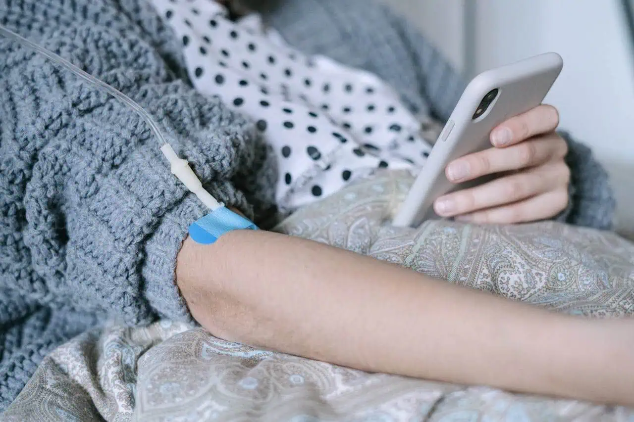 IV therapy patient receiving medication through IV line in hospital bed.