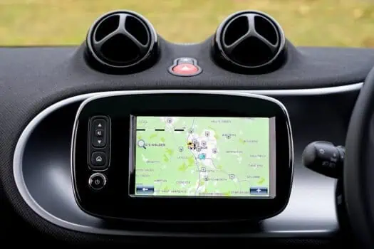 Navigate in a car with GPS navigation system on dashboard, modern vehicle technology, digital map display, driving assistance, vehicle interior gadgets.