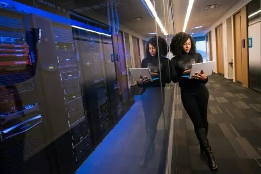 High-tech data centre with women monitoring server equipment, highlighting employment opportunities and diversity in IT and cybersecurity industries.