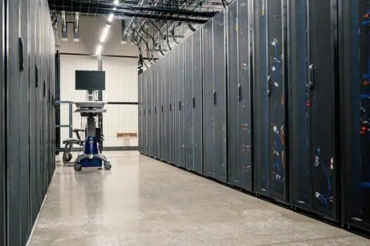 Server room with data centre racks and network equipment in a high-tech data processing facility.