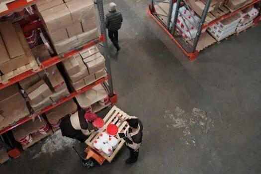 - Shelving units stocked with cardboard boxes and packaging materials in a warehouse.