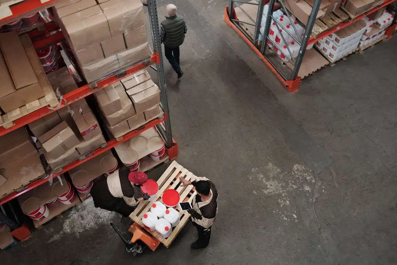 - Shelving units stocked with cardboard boxes and packaging materials in a warehouse.