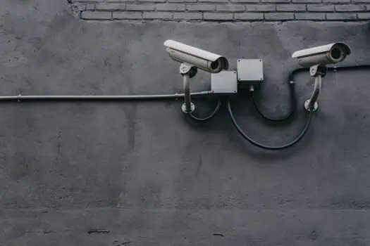 CCTV security cameras mounted on a grey concrete wall, ensuring safety and surveillance for business or residential property.
