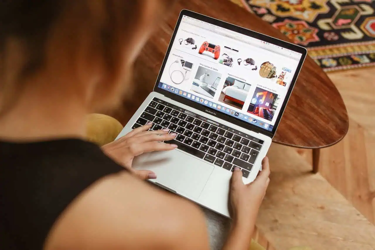 E-commerce woman shopping online on a MacBook laptop devices for technology and gadgets.