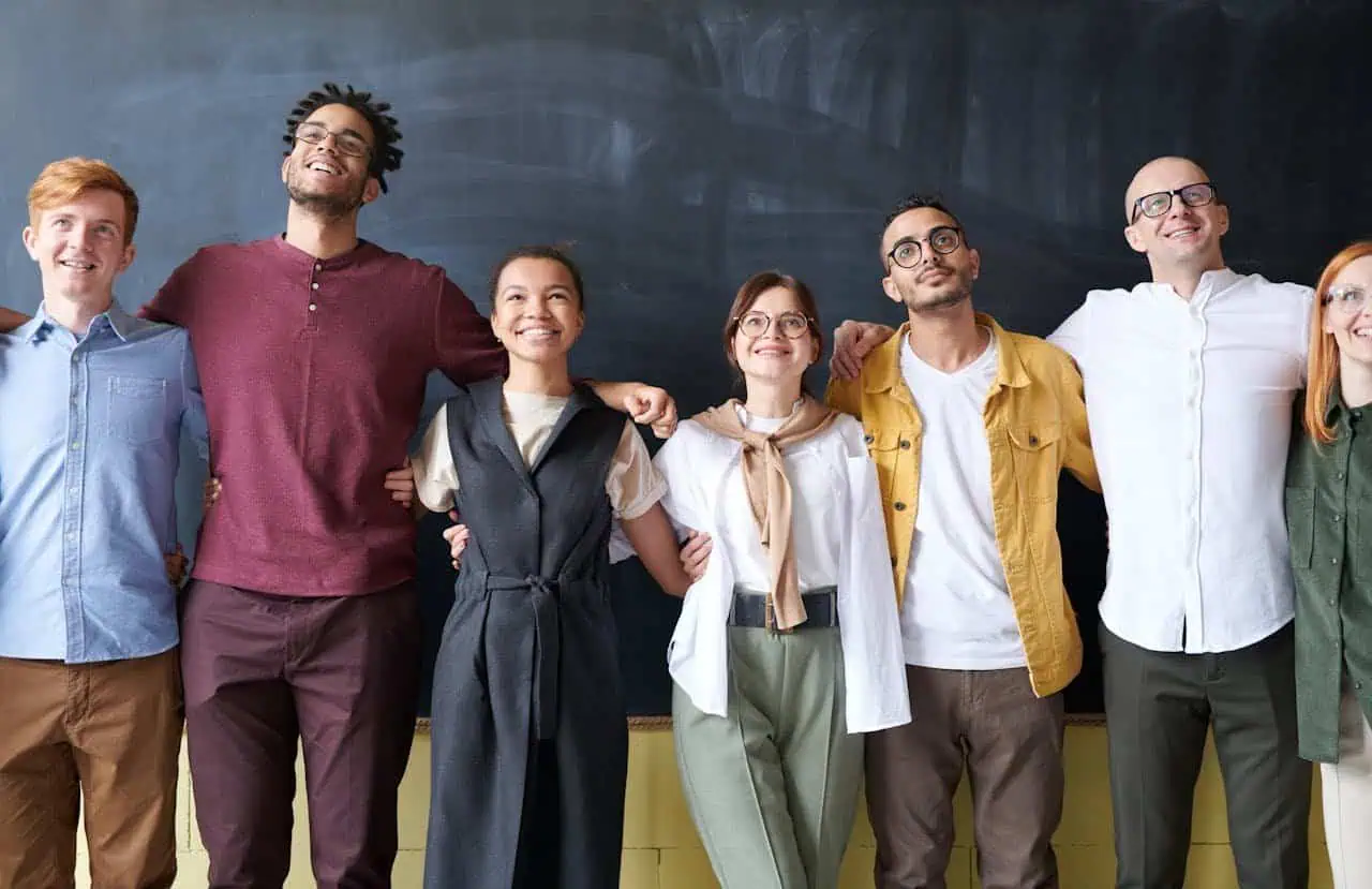 Diverse-group-of-young-people-having-fun-together-in-classroom.