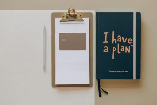 Organised workspace with planner, pen, and financial card illustrating personal planning and goal setting.