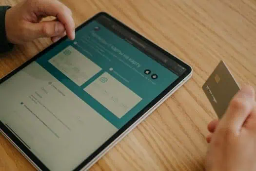 Online banking through a tablet and credit card for accessible financial management.