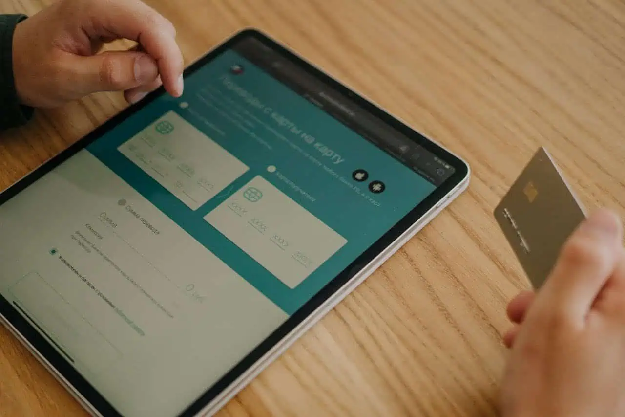 Online banking through a tablet and credit card for accessible financial management.