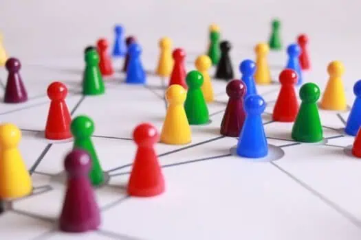 Multicoloured game pieces on a network diagram representing teamwork, collaboration, and social skills development in special education and inclusive classrooms.
