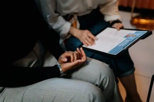 Support worker conducting a talk with a person in a mental health or wellbeing session, highlighting mental health support, therapy, and counselling services.