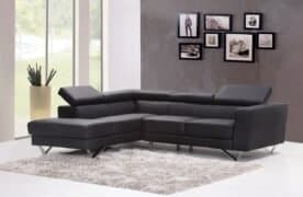 Black leather sectional sofa in modern living room with photo collage wall decor, large windows, and neutral colour scheme. Perfect for contemporary interior design and cosy family gatherings.