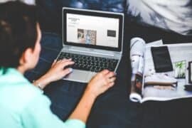 Laptop screen displaying interior design website with creative project ideas, person working remotely on home décor planning, inspiring DIY home improvement concept.