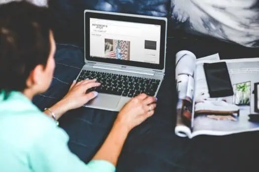 Laptop screen displaying interior design website with creative project ideas, person working remotely on home décor planning, inspiring DIY home improvement concept.