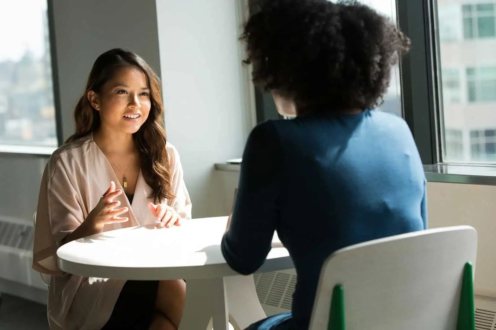 Supportive career guidance session between two women in an office setting.