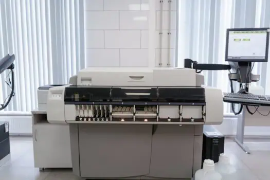 High-tech laboratory equipment for medical testing and diagnostics, with computer monitor and laboratory analysis machine, in a clean and modern medical laboratory setting, healthcare diagnostics and lab automation technology.