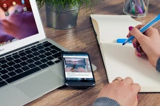 Modern workspace with a laptop, smartphone, notepad, and pens, symbolising online learning and digital opportunities at Prowess. Ideal for visualising education, digital skills, and career development initiatives.