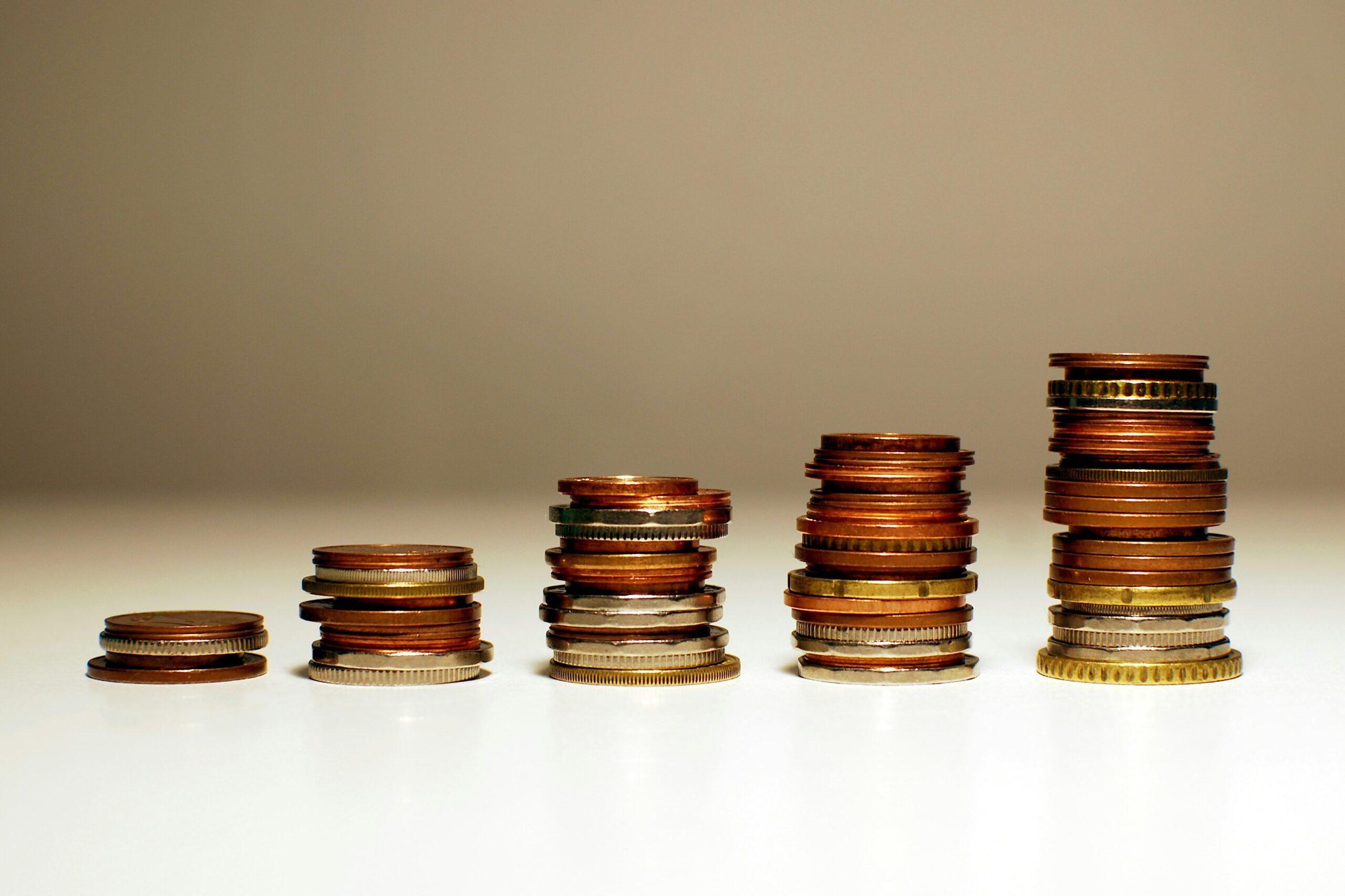Stacked coins in five columns which are increasingly growing