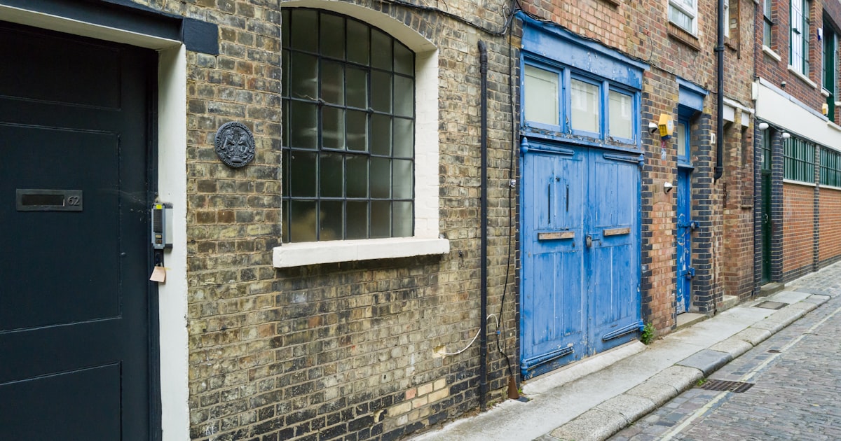 a brick building with blue doors and windows
