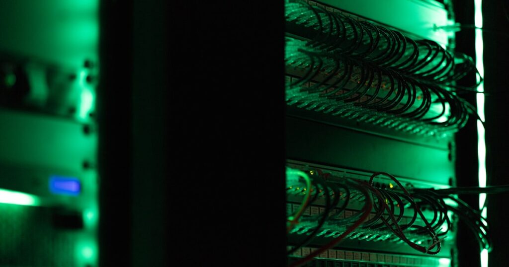 a rack of electronic equipment in a dark room