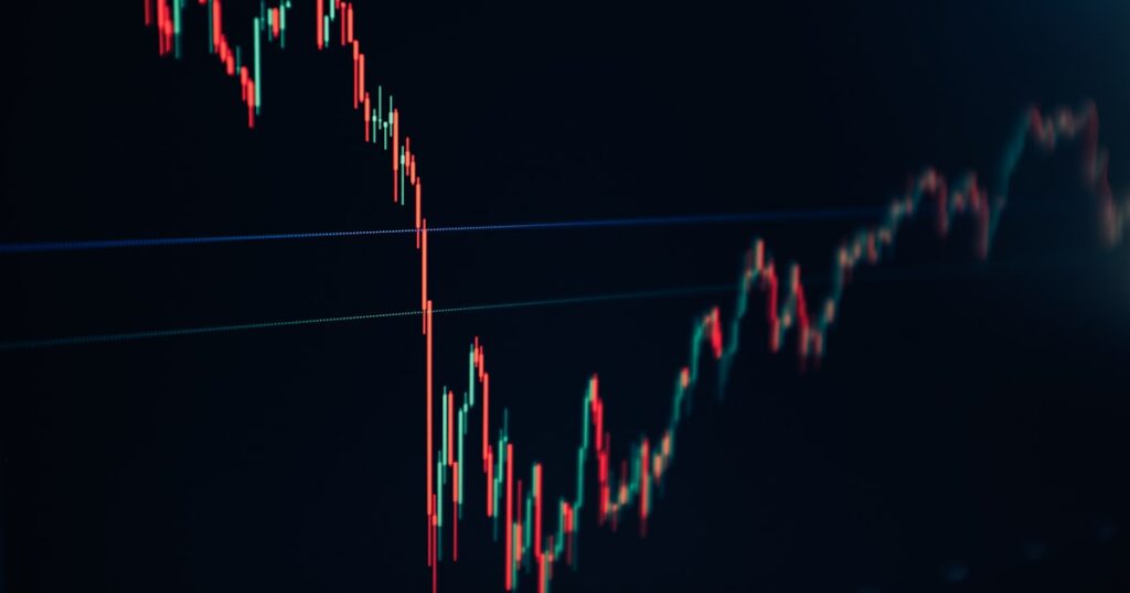 candlestick stock chart on dark screen