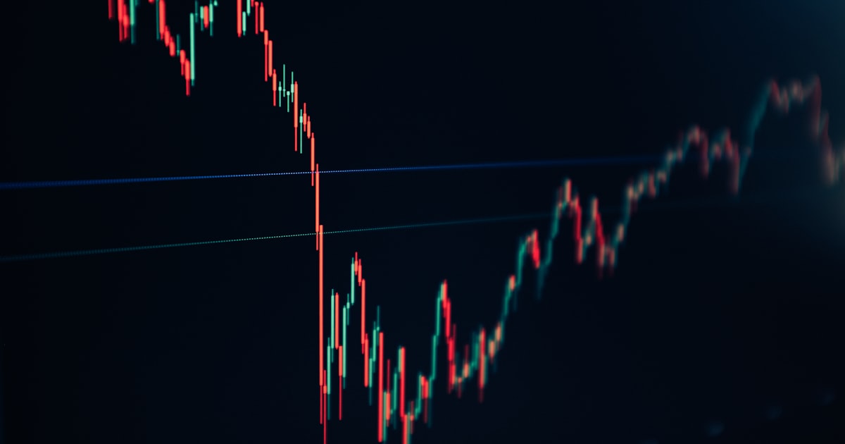 candlestick stock chart on dark screen