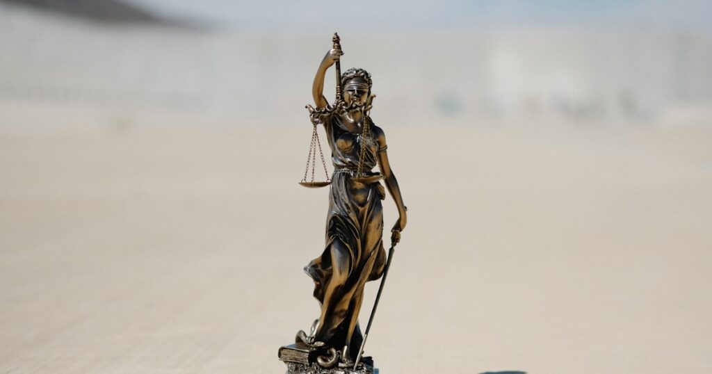 a statue of a lady justice holding a scale