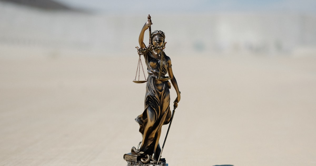 a statue of a lady justice holding a scale