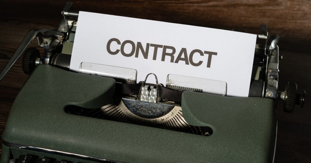a close up of a typewriter with a sign that reads contact