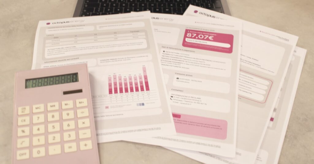 Bills, calculator, and a laptop: financial tasks underway.