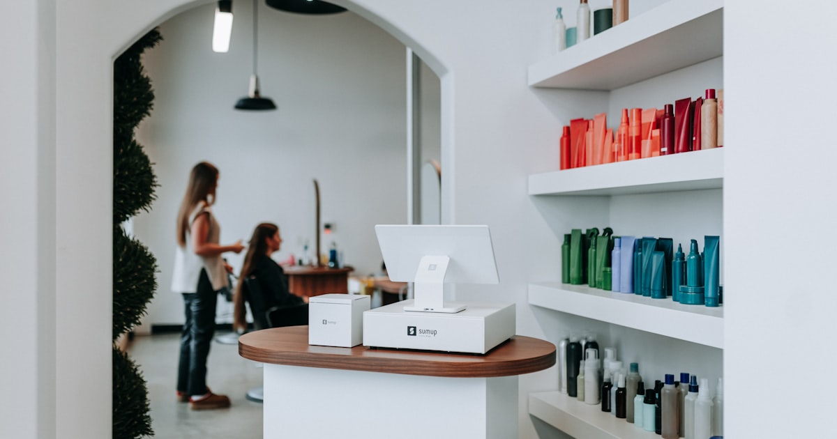 A hair salon interior with hair products and clients.