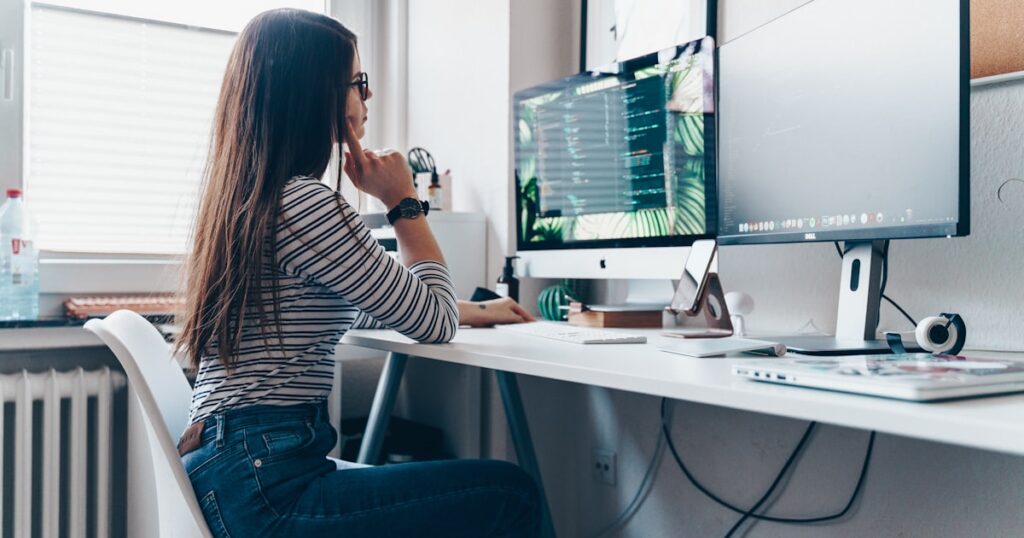 girl using desktop computer in room